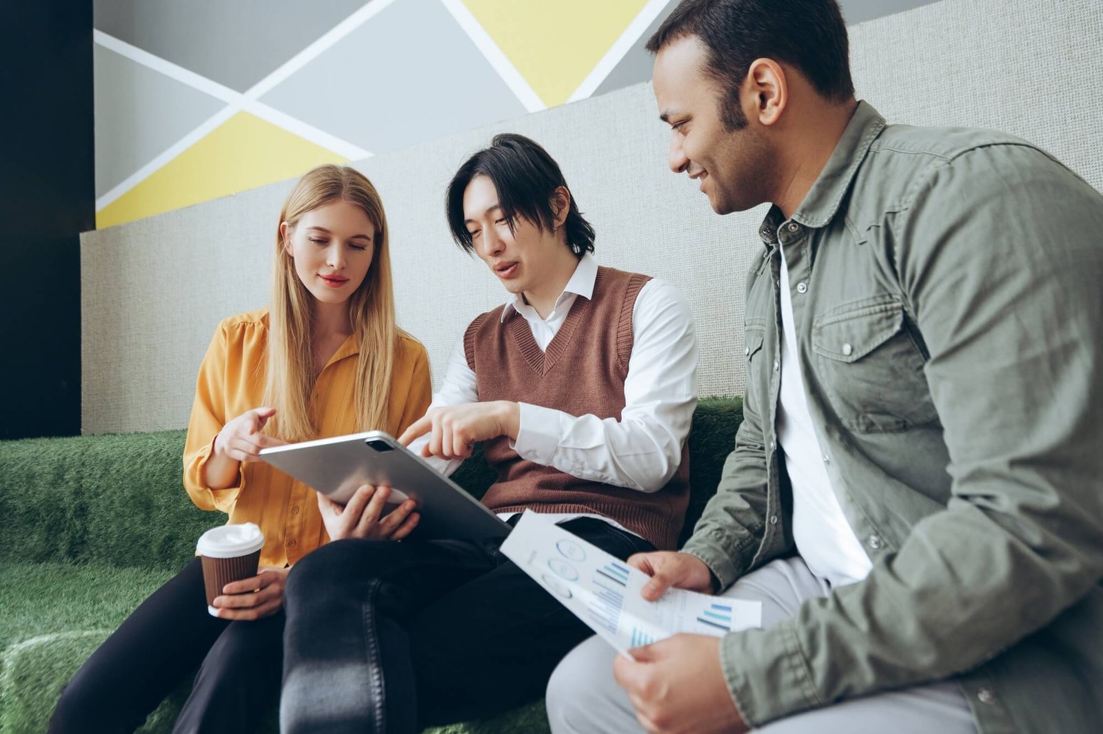 marketing-team-analyzing-data-and-working-on-digital-tablet-and-documents.jpg